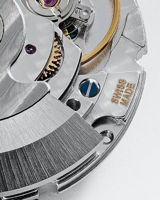 An open caseback, exposing the inner components of a watch